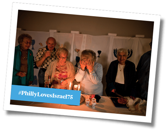 Photo of elderly people lighting Shabbat candles